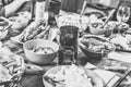 Dinner table. Happy Friends at the dinner table with various snacks, preparations for homemade hot dogs, clinking with wine glass Royalty Free Stock Photo