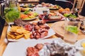 Dinner table with meat grill, roast new potatoes, vegetables, salads, sauces, snacks and lemonade, top view. Royalty Free Stock Photo