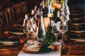 Dinner table setting. Banquet or holiday background in a rustic atmosphere.  Vintage decoration of reception table. Elegant Royalty Free Stock Photo