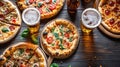 Dinner table with various delicious food. Italian pizza, beer, top view