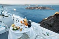 Dinning with cliff top views of the volcanic caldera in Santorini Royalty Free Stock Photo