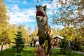 Dinosaur carnotaur. Model in full size against a background of trees Royalty Free Stock Photo