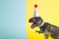 a dinosaur, dressed up in lace and a paper party hat