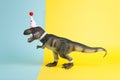 a dinosaur, dressed up in lace and a paper party hat