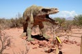 Dinosaur model in the sand Royalty Free Stock Photo