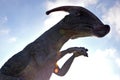 Dinosaur Parasaurolophus against blue sky with clouds Royalty Free Stock Photo