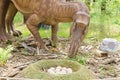Dinosaur Park, dinosaur model Maiasaura with a clutch of eggs Royalty Free Stock Photo