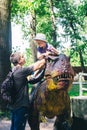 A close-up of a full-length mini Tyrannosaurus Rex. Reconstruction of extinct species. Swing for children. Styling extinct animals