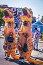 Dinosaurs on the town - Two women in inflatable T-Rex Costumes with handbags and Quick Trip Styrofoam drink