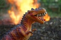 Dinosaurs Tyrannosaurus rex model running away from forest fire