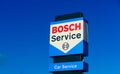 Isolated blue red logo lettering of Bosch car service against cloudless blue sky
