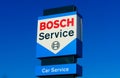 Isolated blue red logo lettering of Bosch car service against cloudless blue sky