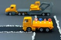 Diorama road construction with yellow construction machinery models