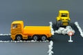 Diorama road construction with yellow construction machinery models