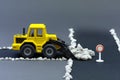 Diorama road construction with yellow construction machinery models