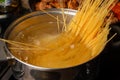 Dip spaghetti into boiling water in a saucepan. Pasta cooking Royalty Free Stock Photo