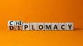 Diplomacy or chiplomacy symbol. Turned wooden cubes and changed the concept word diplomacy to chiplomacy. Beautiful orange