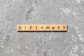 Diplomacy word written on wood block. diplomacy text on cement table for your desing, concept
