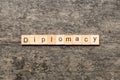 diplomacy word written on wood block. diplomacy text on cement table for your desing, concept