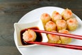 Dipping Shrimp and Pork Filled Chinese Steamed Dumpling in Soy-vinegar Sauce Royalty Free Stock Photo