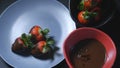 Dipping strawberry into chocolate mixture Royalty Free Stock Photo