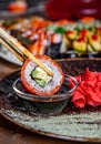 Dipping sushi roll into bowl with soy sauce Royalty Free Stock Photo