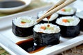 dipping sushi into soy sauce with chopsticks Royalty Free Stock Photo