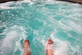 Dipping toes in warm bubbly hot tub