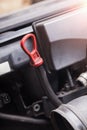 The dipstick for checking the oil level in black with a red handle close-up against the background of engine assemblies. A Royalty Free Stock Photo