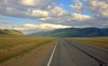 A direct asphalt road running through the valley rests on the mountains