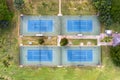 Direct overhead view of four tennis courts