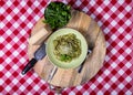 Direct Overhead View of Meaty Green Italian Pasta on Red Tablecloth