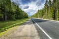 Direct road route through the forest. Smooth asphalt surface Royalty Free Stock Photo