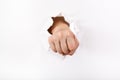 Direct view of the fist punches a paper Royalty Free Stock Photo