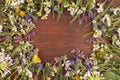 Direct view, wooden background in the center, wild flowers on the contour of the board surface. Copy space