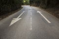 Direction arrows on empty asphalt road Royalty Free Stock Photo