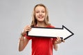 Smiling teenage girl with arrow showing direction Royalty Free Stock Photo