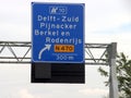 Direction sign in blue and white heading Delft Zuid on motorway A13