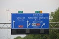 Direction sign in blue and white heading Gouda and Utrecht on motorway A20 / E25 and Breda on the E19