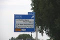 Direction sign in blue and white heading Rotterdam the Hague Airport and industrial zones on motorway A13