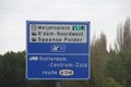 Direction sign in blue and white heading Rotterdam parking lots and industrial zones on motorway A13