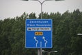 Direction sign in blue and white heading Zevenhuizen and Rotterdam Nesselande on regional road N219