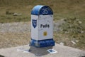 Direction sign distance indicator next to the road. Padis, Romania. Color illustration photo of tourism, traveling.