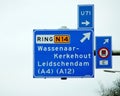 Direction sign on regional route N14 to Wassenaar with also alternative route U71 and alternative for dangerous goods transport.