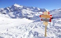Direction sign at ski resort in the Italian Alps. Winter mountains panorama with wooden sign indicating the path. Abstract concept Royalty Free Stock Photo