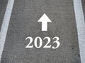 Direction 2023 written on asphalt road. New Year 2023 concept
