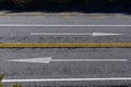 Directional arrows are painted on a road in New Zealand to ensure drivers stay driving on the left side of the road Royalty Free Stock Photo