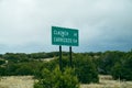 Directional mileage road sign in New Mexico for two small towns - Claunch and Carrizozo