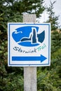 Directional sign for the the Skerwink hiking trail along Trinity Bay in Atlantic Canada.