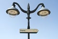 Directional sign on street lamp